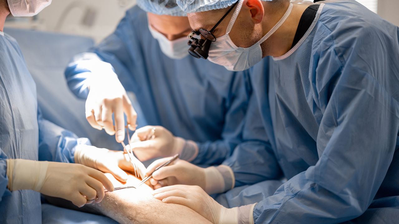 surgeons performing surgical operation on a patient's knee
